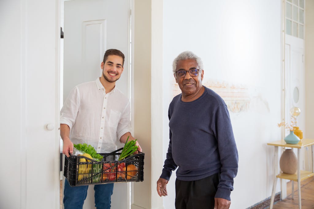 A Man Holding a Plastic Crate with Fruits and Vegetables